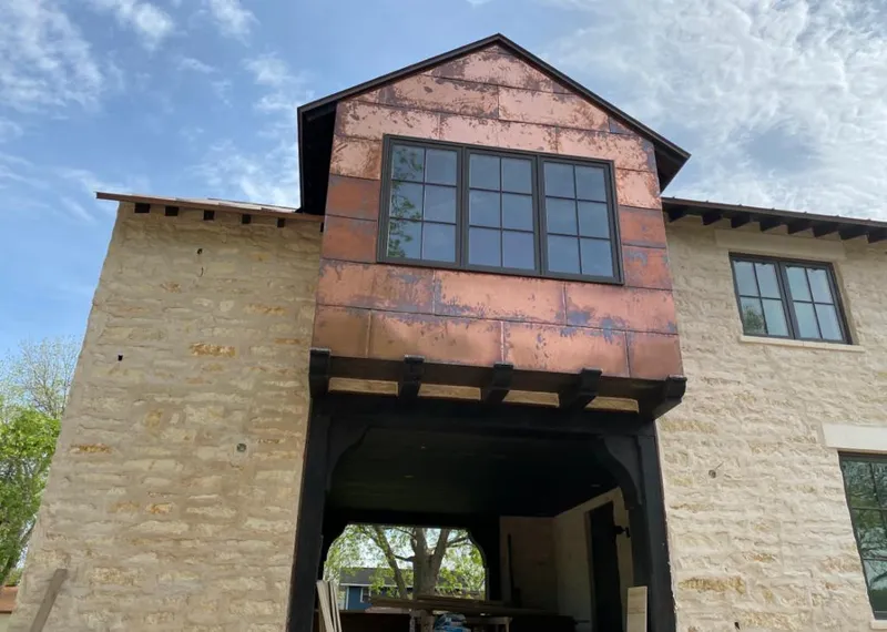 Copper metal panel facade on a stone building for Skylight Installation in Norco