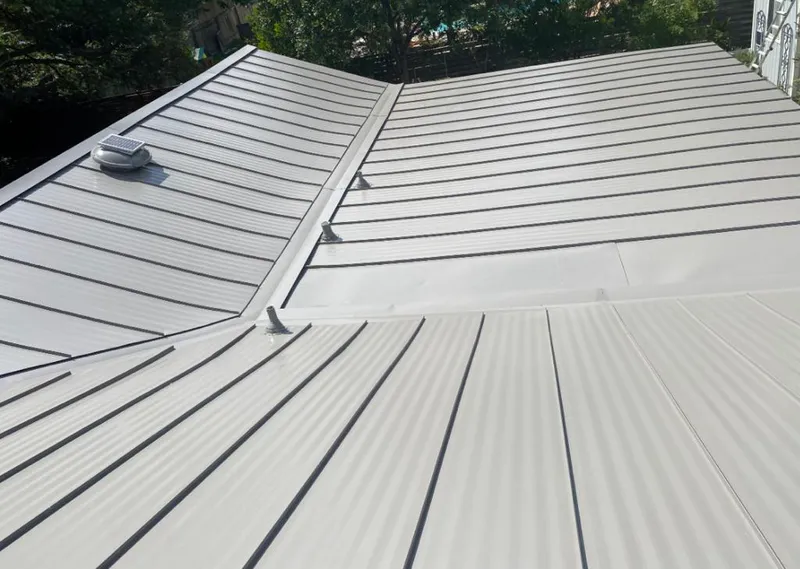 Solar attic fan installed on a metal roof for Roof Ventilation in Norco
